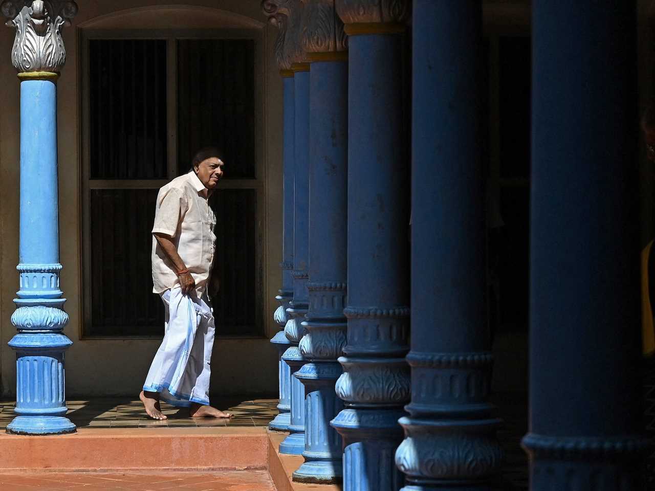 A man walks through a Chettinad mansion in 2021.