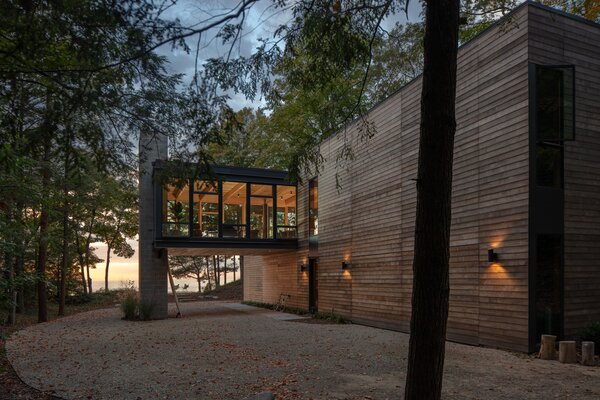 Visitors can use the covered area beneath the living room as a carport, and keeping the space open allows a view of the water when arriving by car.