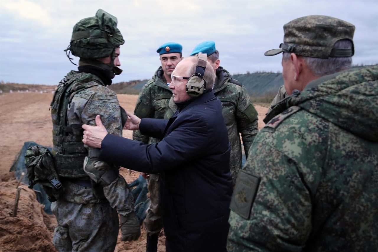 ussian President Vladimir Putin, center, speaks to a soldier as he visits a military training center of the Western Military District for mobilized reservists in the Ryazan region of Russia, on Oct. 20, 2022.