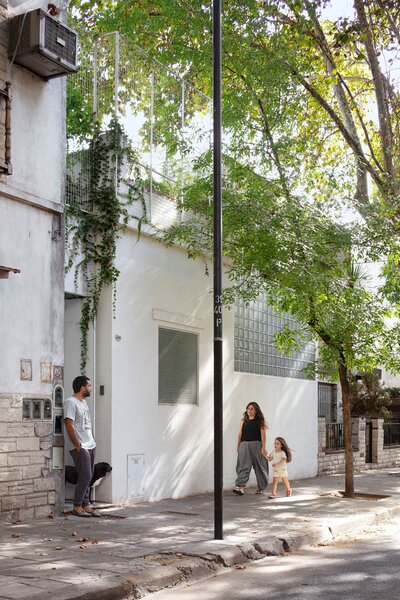 Architect Hernán Landolfo combined two adjacent houses on a sun-dappled street in Buenos Aires to create a home for himself, his partner, Lucía Gentile, their daughter, Luisa, and the family dog, Roca.