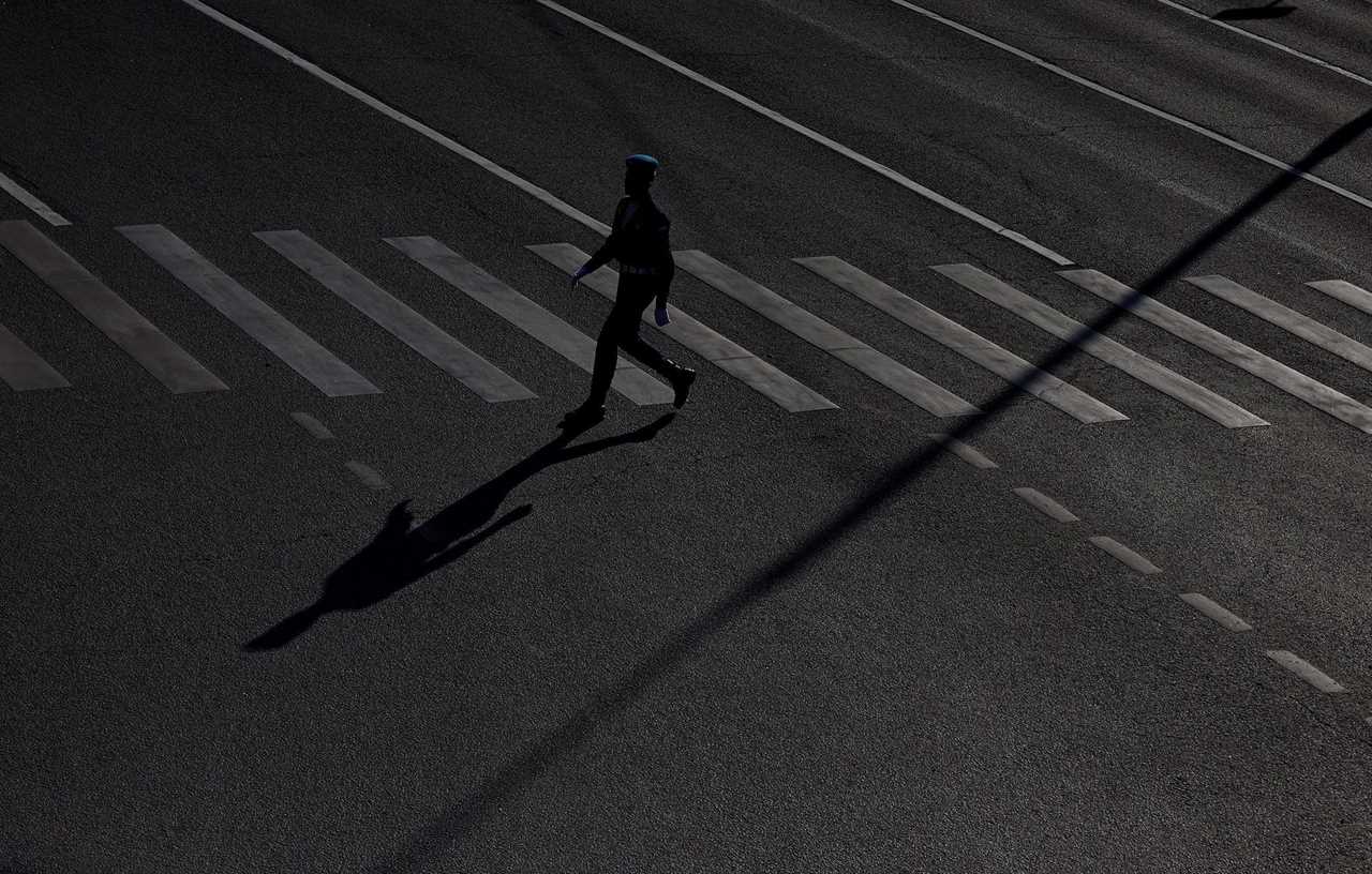 A Russian service member walks across a street before a military parade on Victory Day in Moscow, Russia, on May 9 2023.