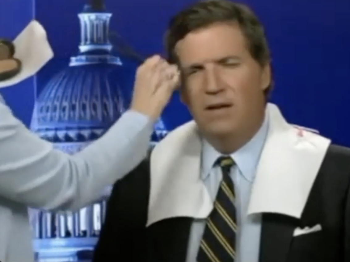 screenshot of Tucker Carlson getting makeup done