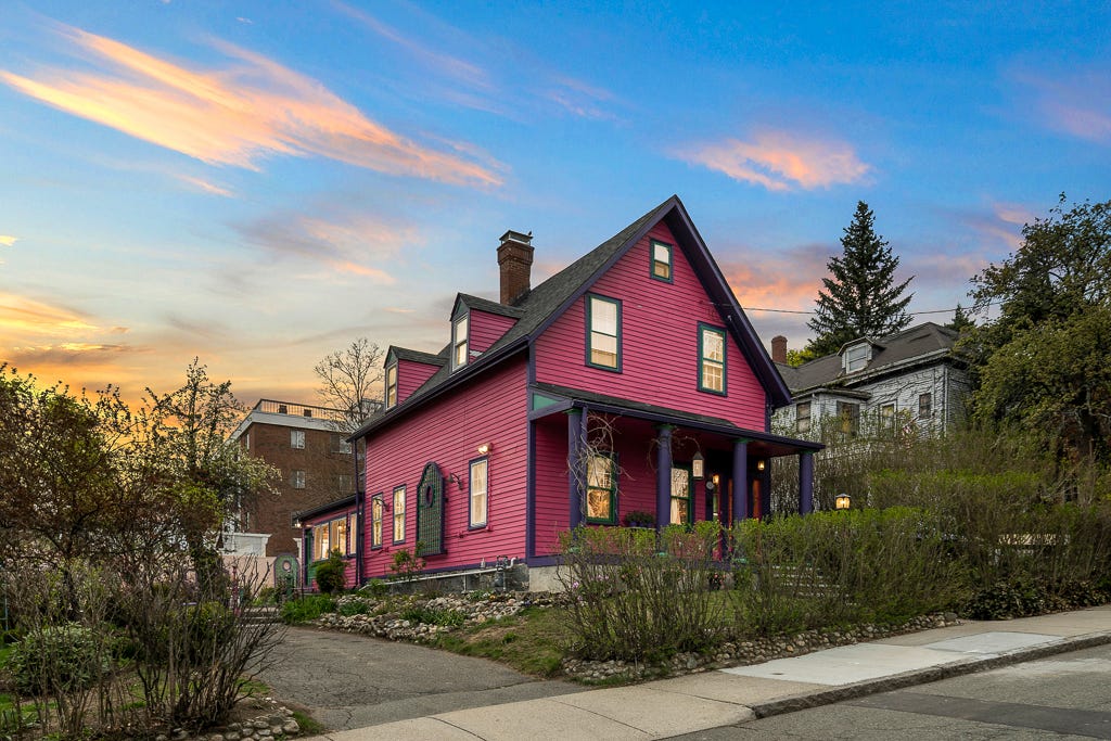 The exterior of a pink Victorian house