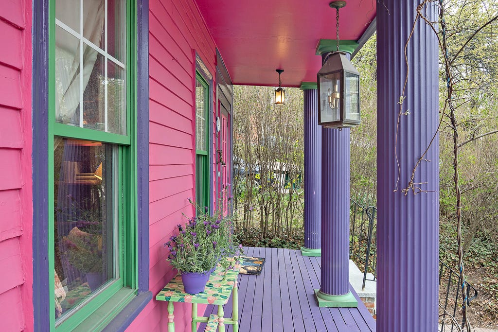 A pink porch with purple columns