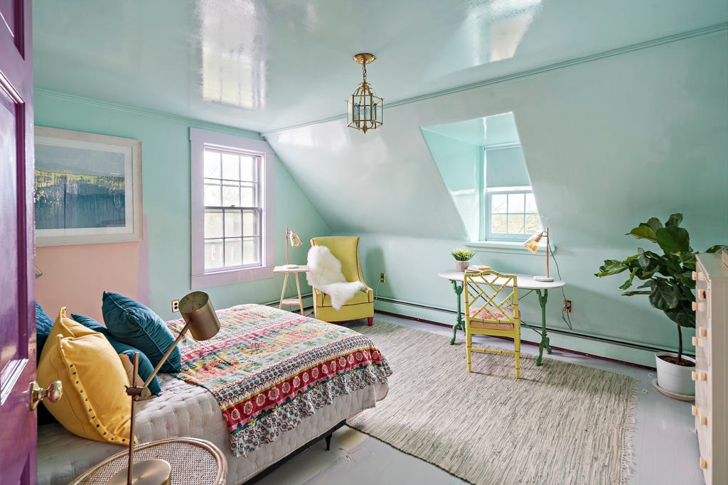 A bedroom with pale blue walls