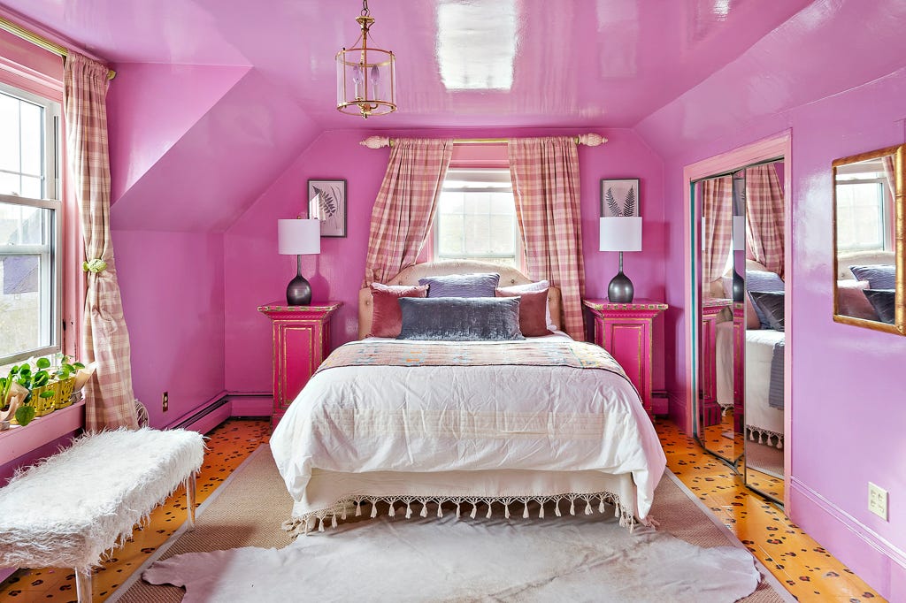 A bedroom with cheetah print floor and pink walls