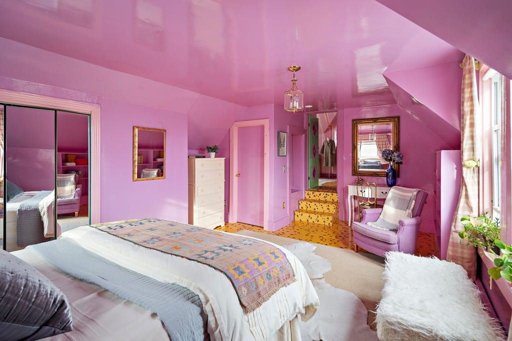 A bedroom with cheetah print floor and pink walls