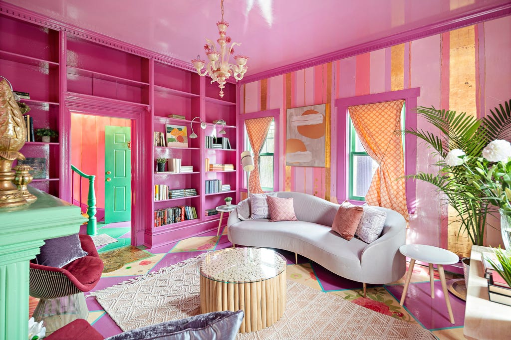 A living room with pink and gold wallpaper