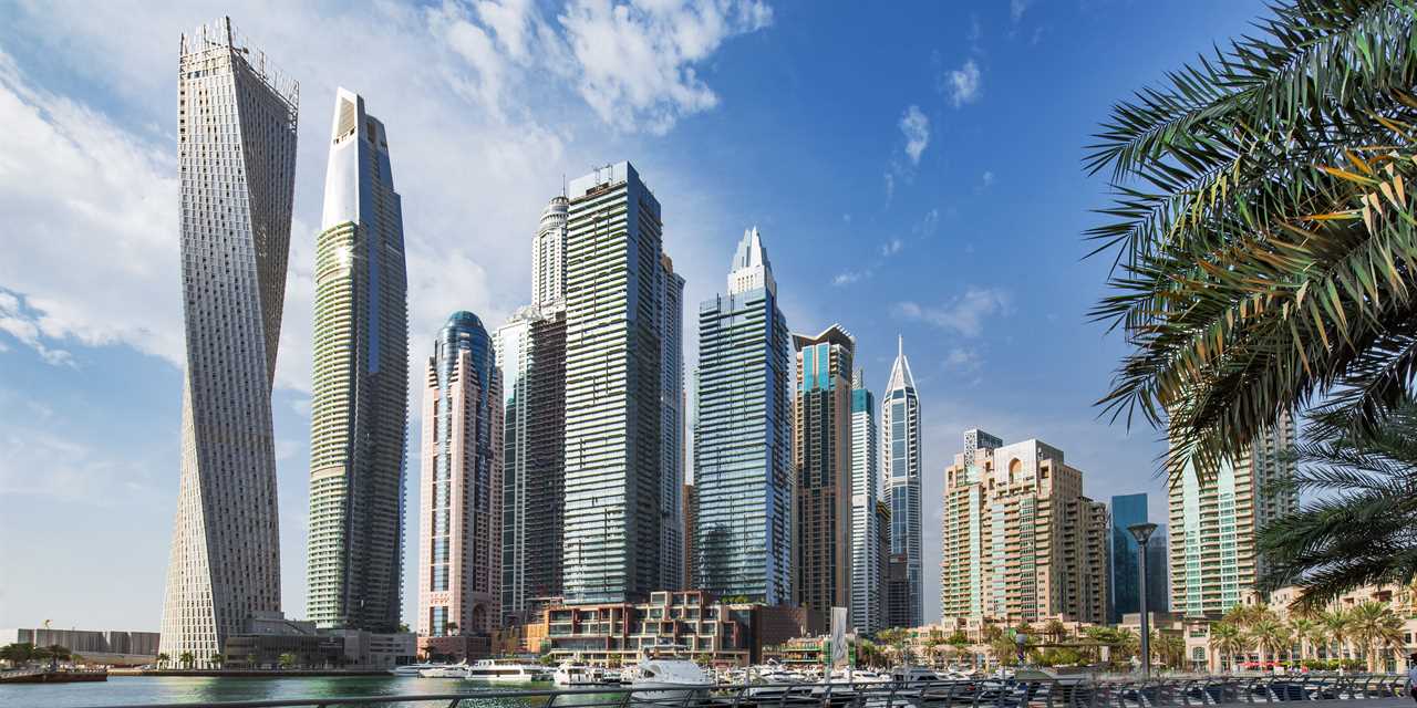 Dubai marina skyscrapers and yachts at blue hour