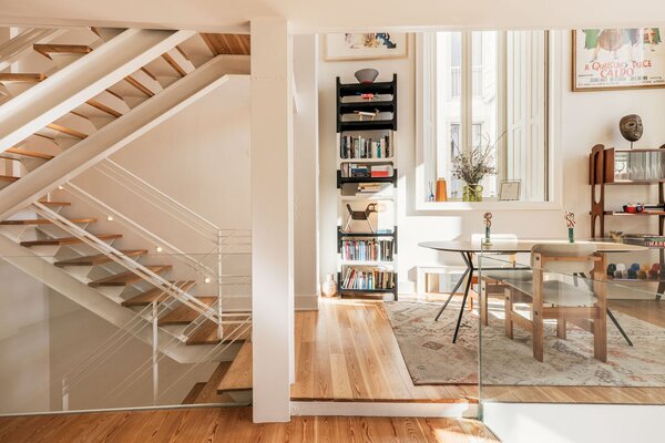 The revamped residence spans 1,593 square feet, with its main living areas spread across four levels. Hardwood floors run throughout, enhancing the home's cohesive aesthetic.