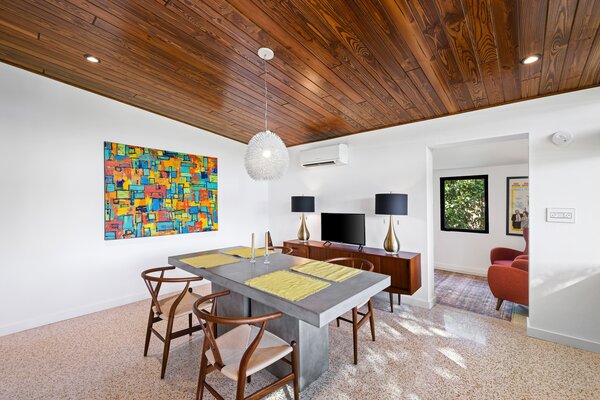 The dining room sits sandwiched between the remodeled kitchen and another seating area.