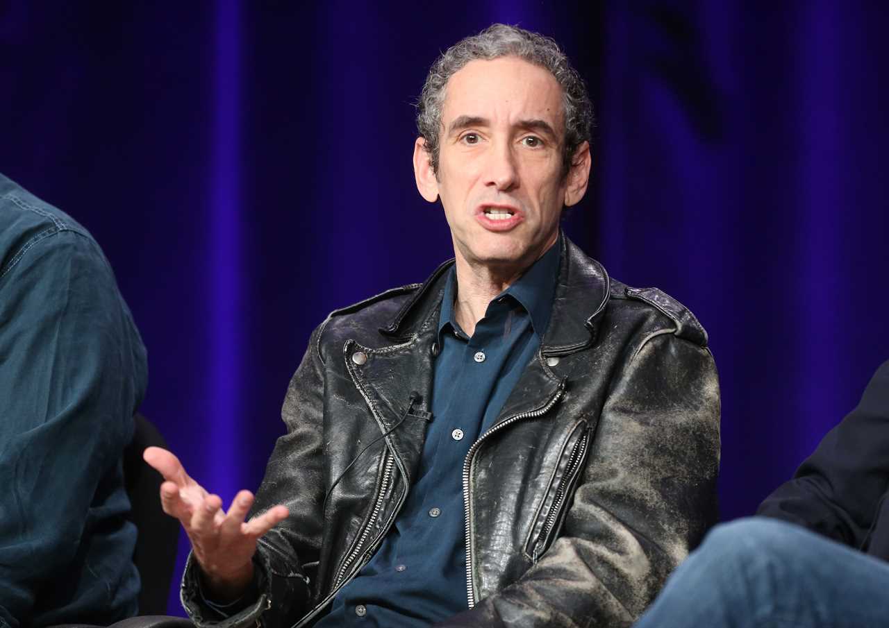 doug rushkoff wearing a navy blue button down and leather jacket while speaking