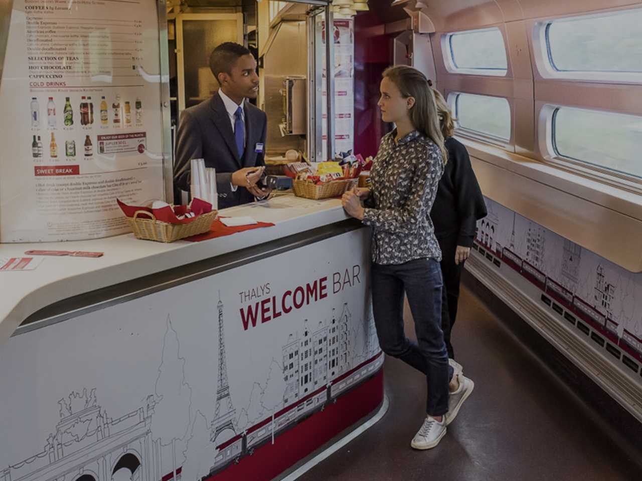 Thalys' Welcome Bar with an attendant helping a guest.