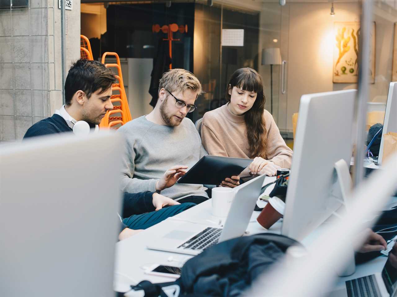 Three people working in an office