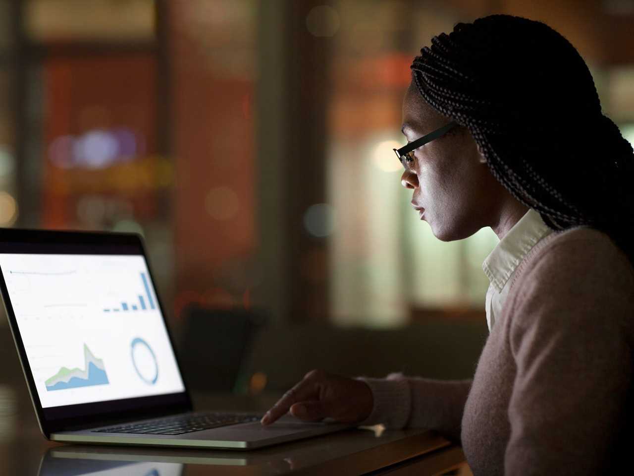 Worker looking at data visualizations on a laptop