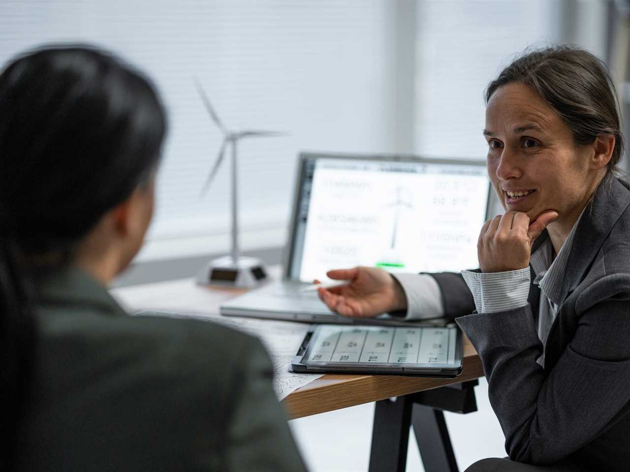 Two people talking in an office