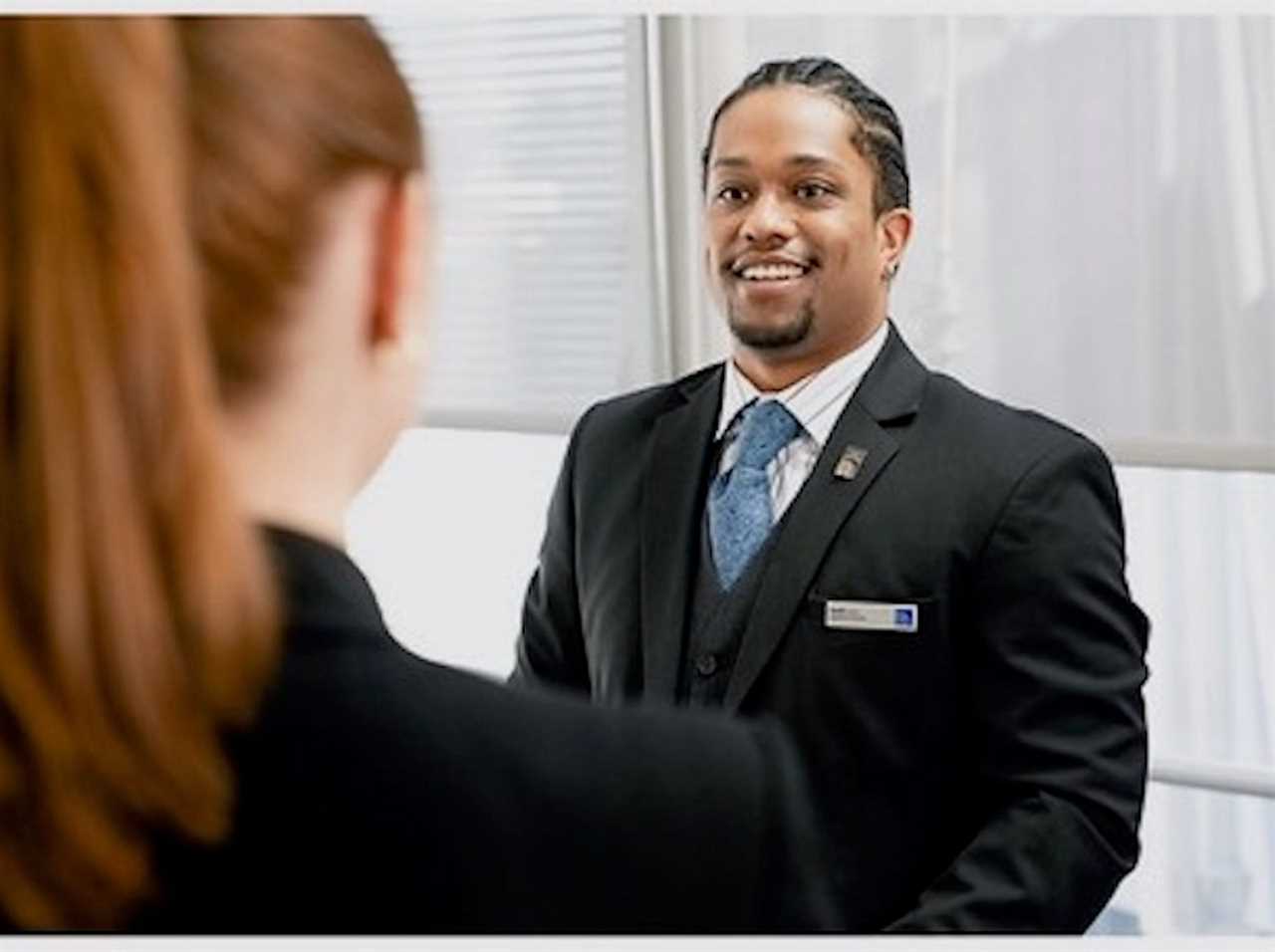 United flight attendants wearing pronoun pins.