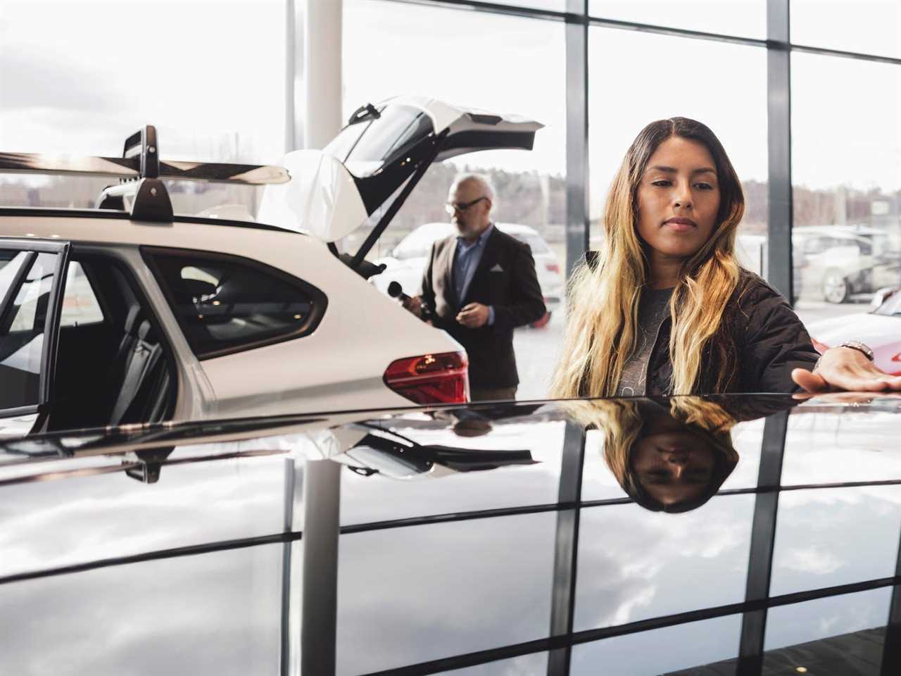 person shopping for a car at a dealership