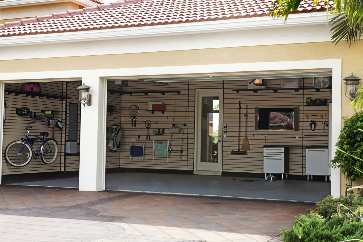 organized garage with everything hung up on the wall to maximize space for cars