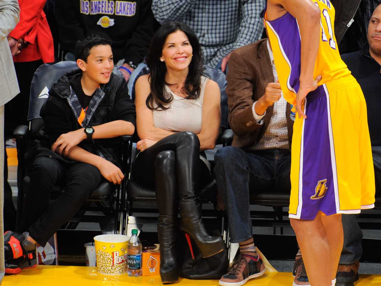 Lauren Sanchez and her son, Nikko Gonzalez, sitting courtside at a Lakers basketball game in 2014.