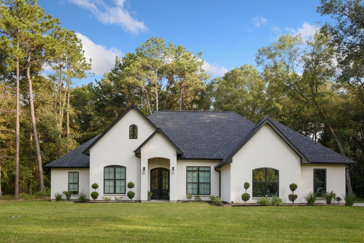 white french country house with trees