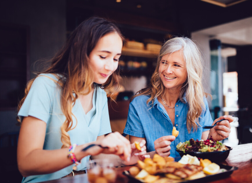 mother and daughter eating lunch together at restaurant