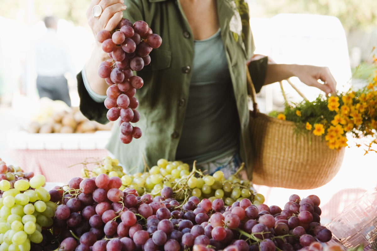 Woman with grapes at farmer's market