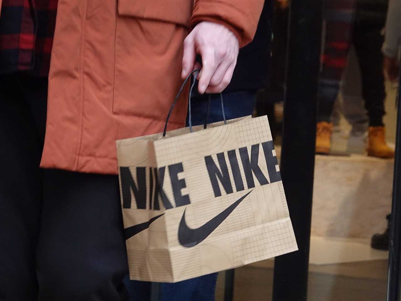 A shopper leaves a Nike store in Chicago