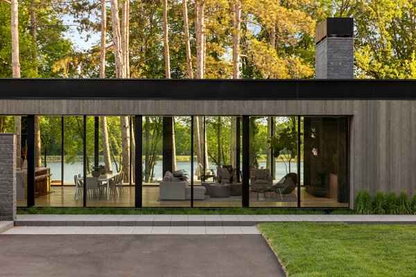 Glazing on both sides of the home and an open floor plan allows for beautiful water and forest views throughout the living space.