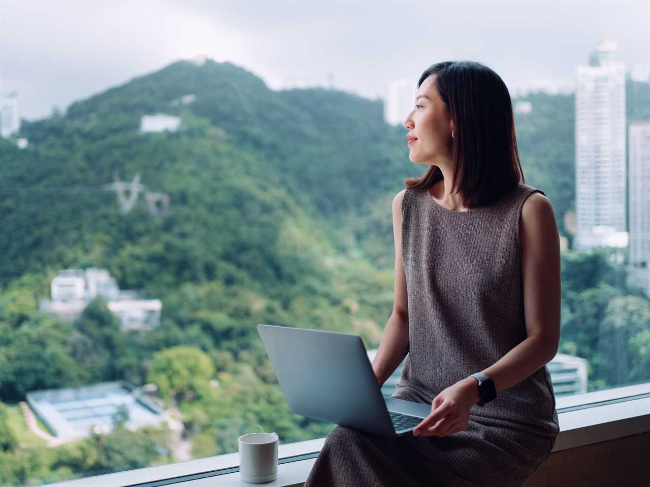 business woman looking outside of window