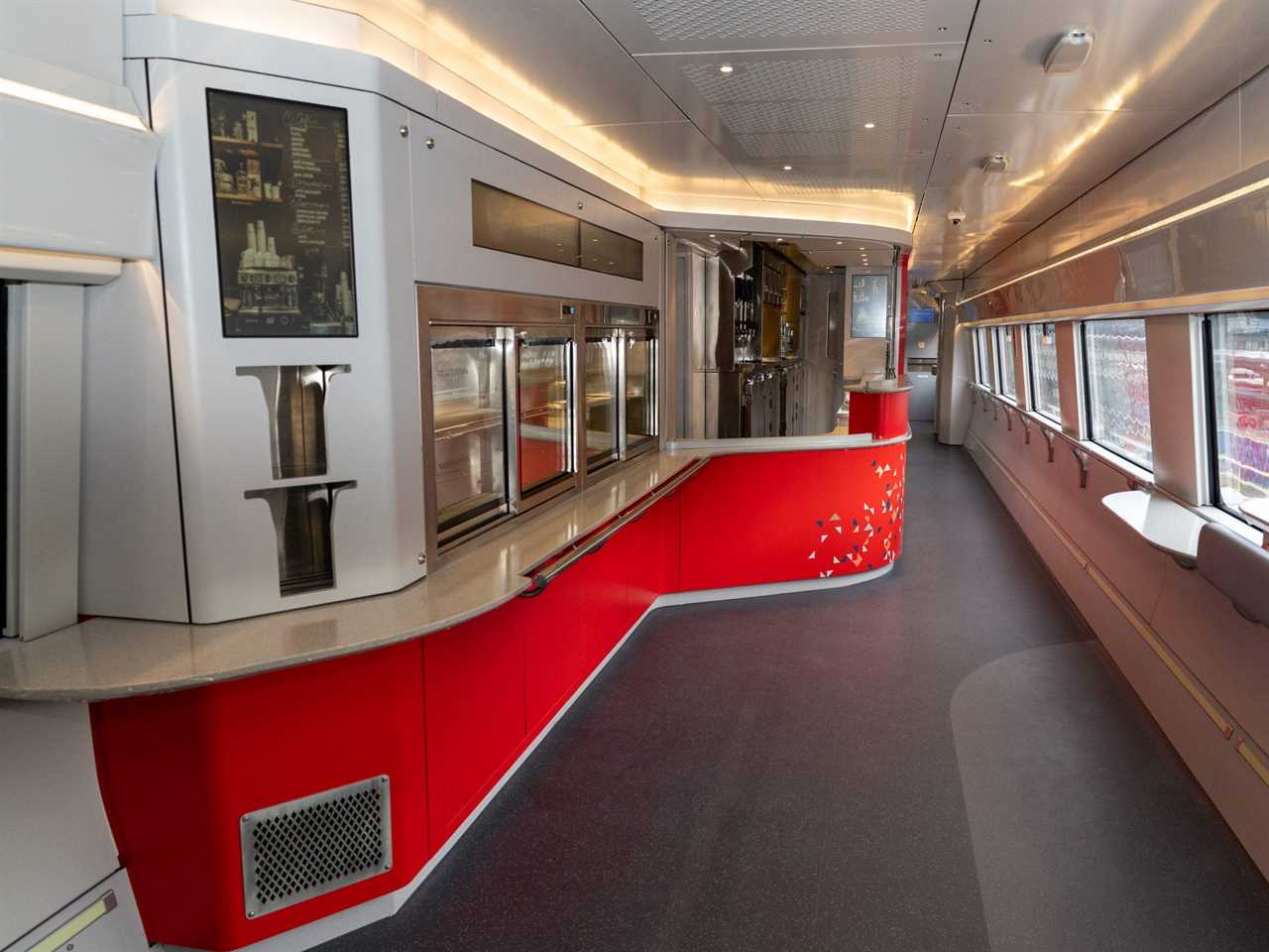 The cafe car in the new Amtrak Acela. There's a cafeteria-style counter and large windows.