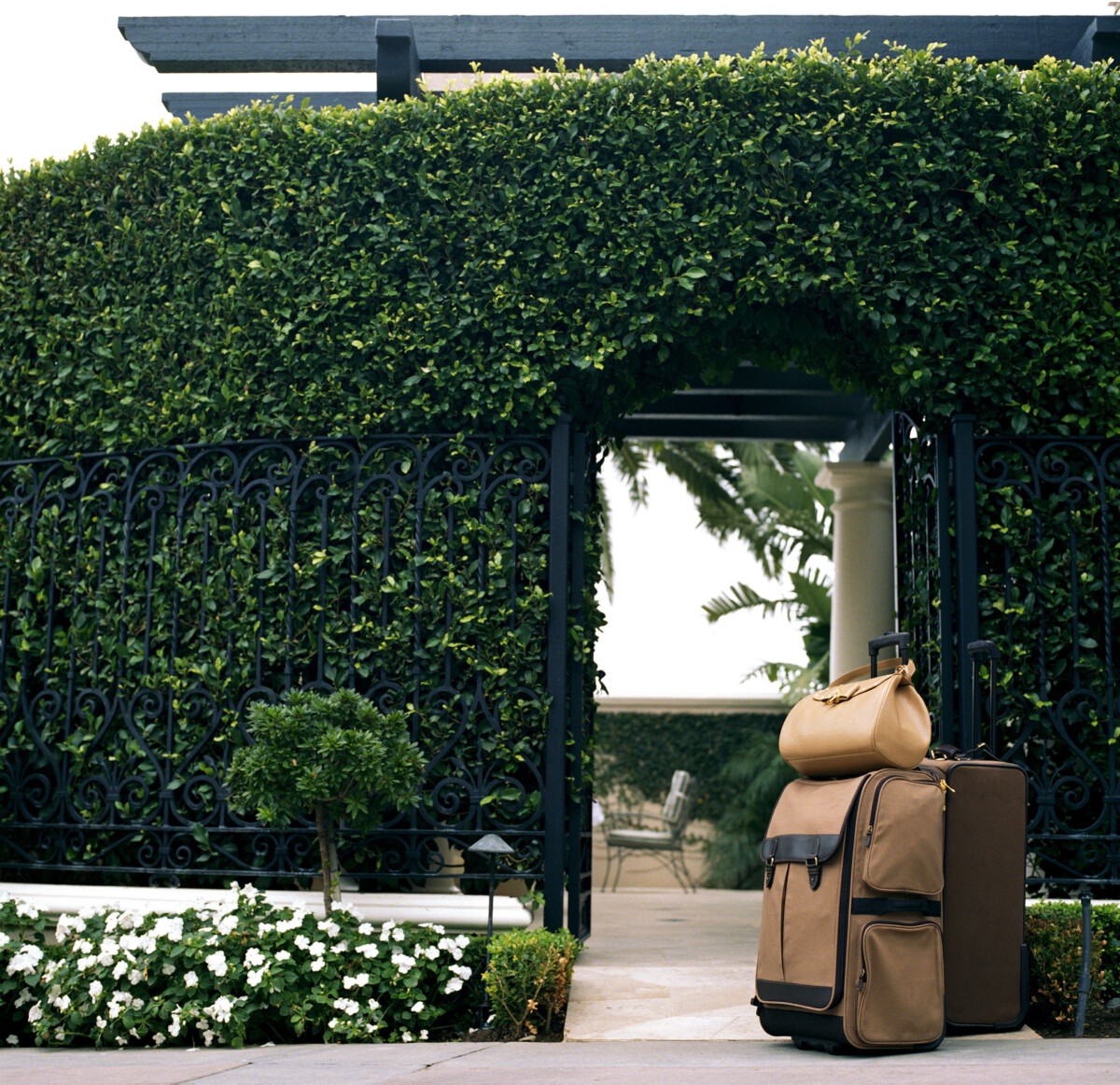 Luggage sitting in front of hotel gate