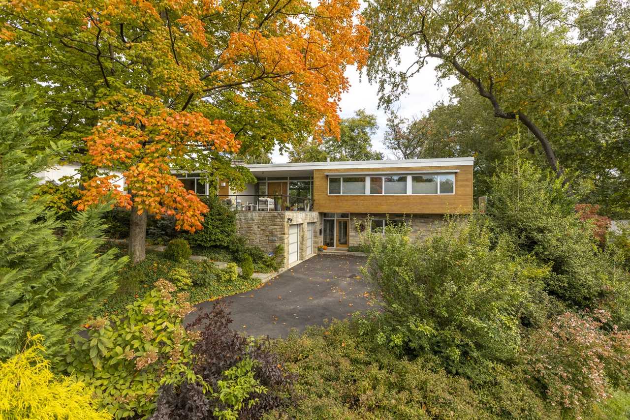 Though conveniently located to Washington, D.C., the multi-story residence offers a quiet city escape, tucked away on a lush, tree-filled lot.