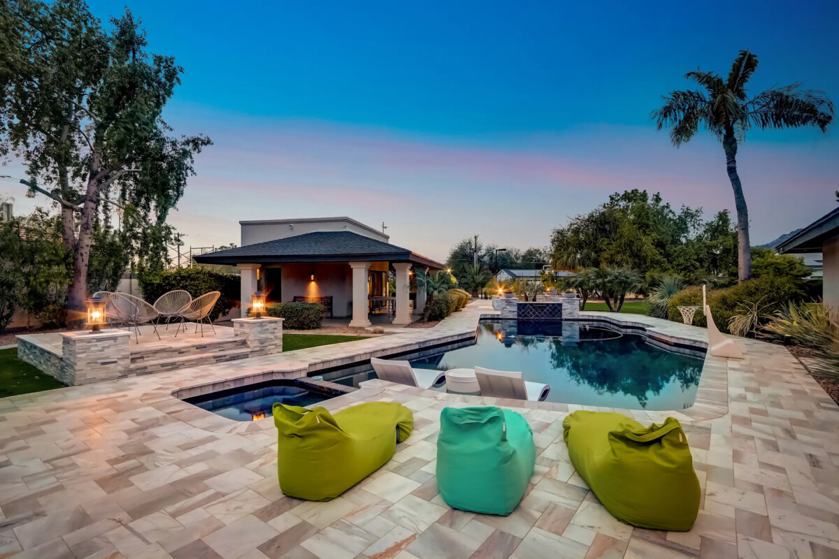 tropical backyard pool at dusk