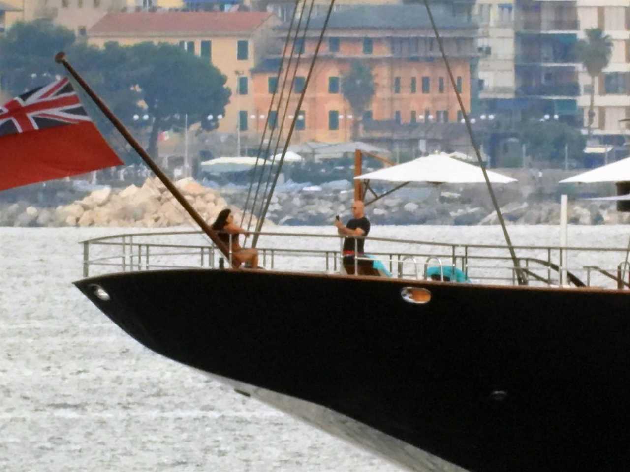 Jeff Bezos taking a photo of Lauren Sanchez on a yacht.