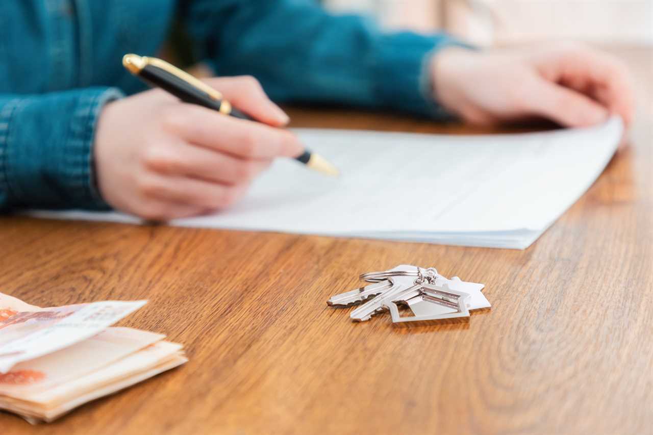 woman signing a contract for the rental or purchase of real estat