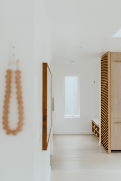 The entryway—minimal and devoid of color—sets the serene aesthetic of the house. 