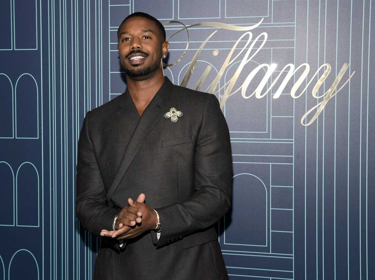 Michael B. Jordan stands in front of Tiffany backdrop