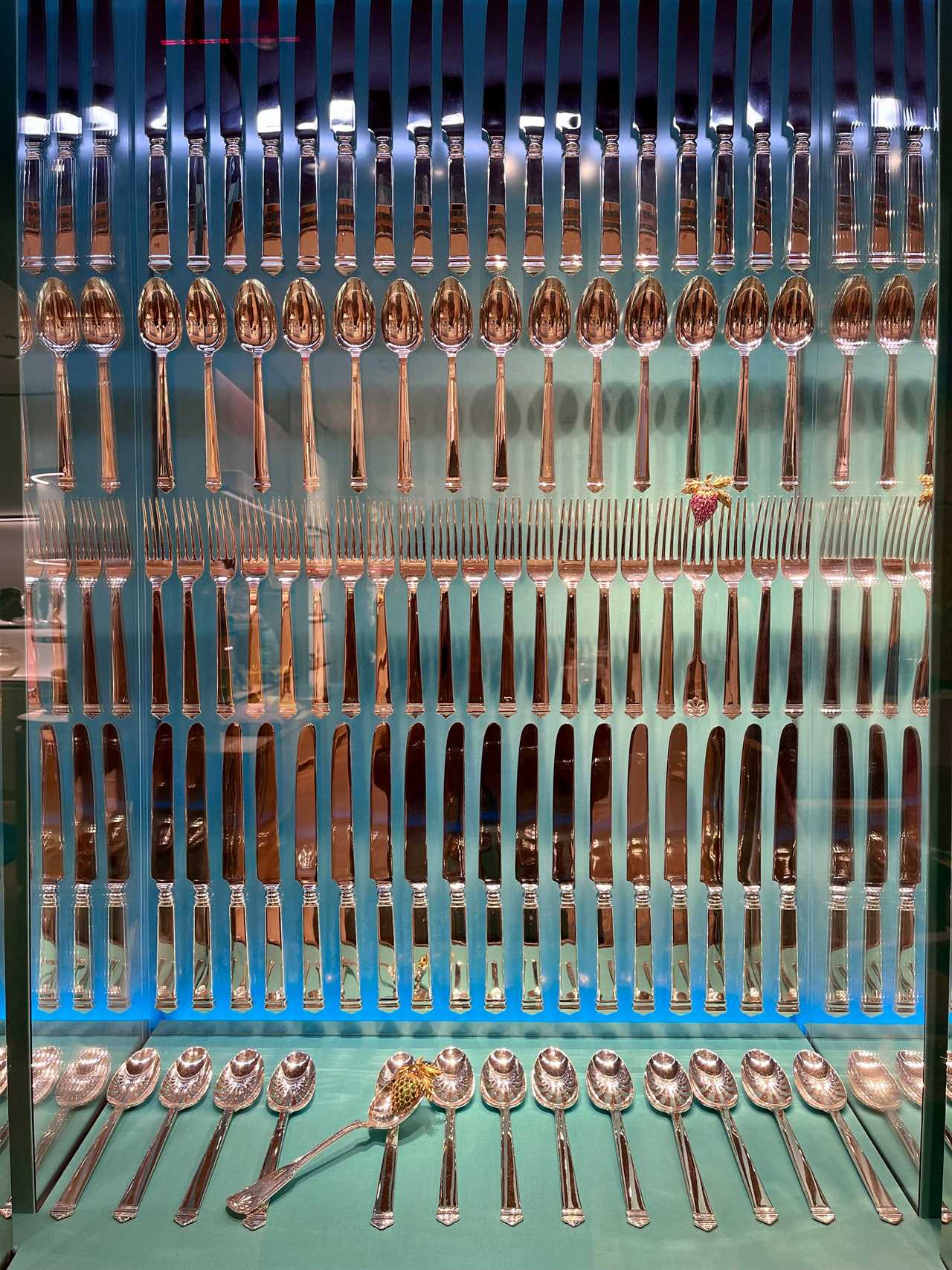 Artistic display of rows of Tiffany knives, forks, and spoons at Tiffany store