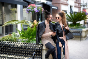 couple smiling at each other as they are out shopping