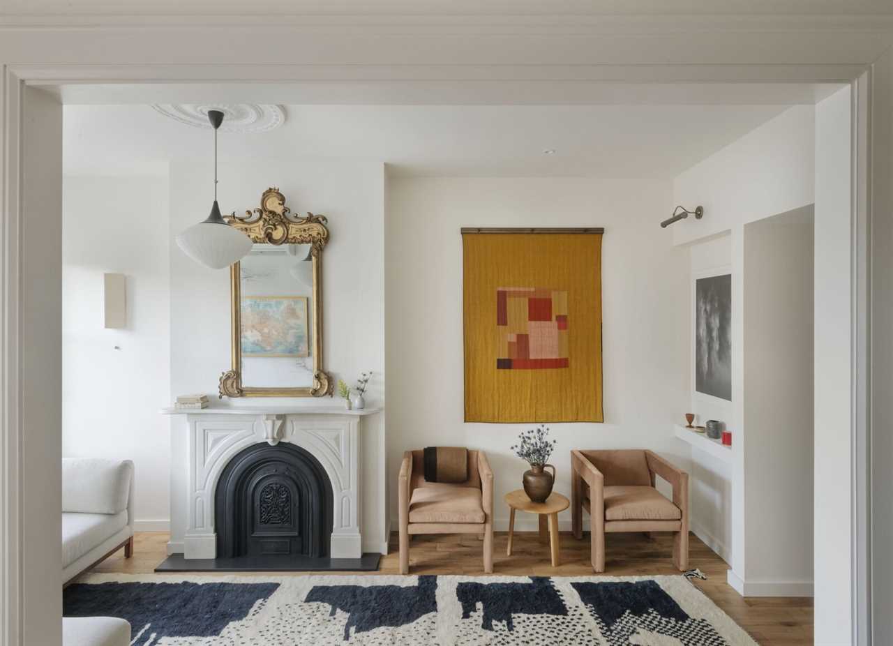 Two Angle II Armchairs from TRNK sit below a quilt by Catherine-Marie Longtin.