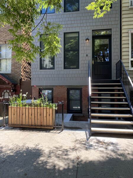 An iphone picture from the owners shows how the front façade was reworked. The basement entry was kept, and a new first floor entry added, then given a steel stoop that reflects brownstone proportions but has a modern materiality.