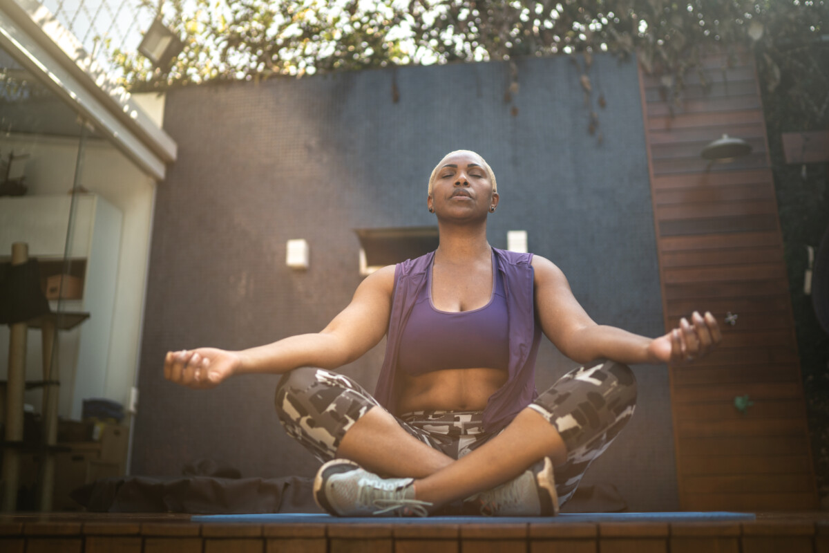 Woman meditating in the backyard