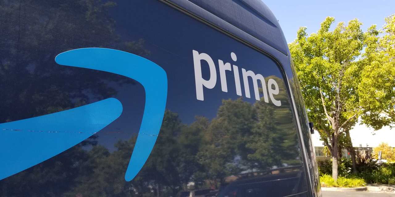 A delivery van with the Amazon Prime logo on it.