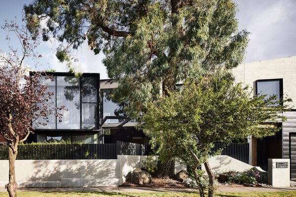 A Black Steel Stair Anchors the Addition of This Raw Concrete Home in Melbourne