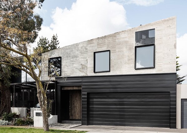 A Black Steel Stair Anchors the Addition of This Raw Concrete Home in Melbourne