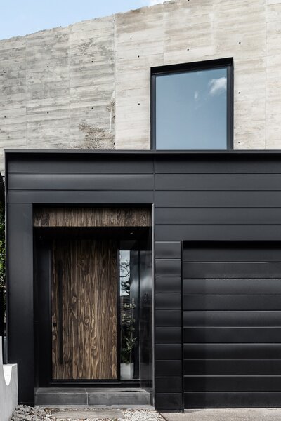 A Black Steel Stair Anchors the Addition of This Raw Concrete Home in Melbourne