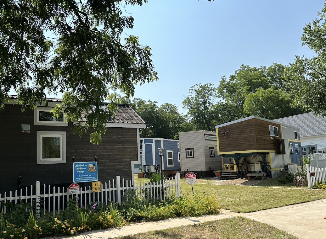 A few homes in front of the entrance of the Lake Dallas Tiny Home Village.