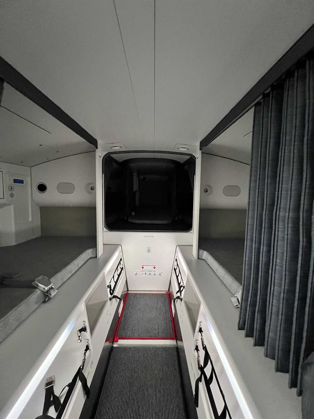 A head-on view of the beds and curtains in the crew rest area