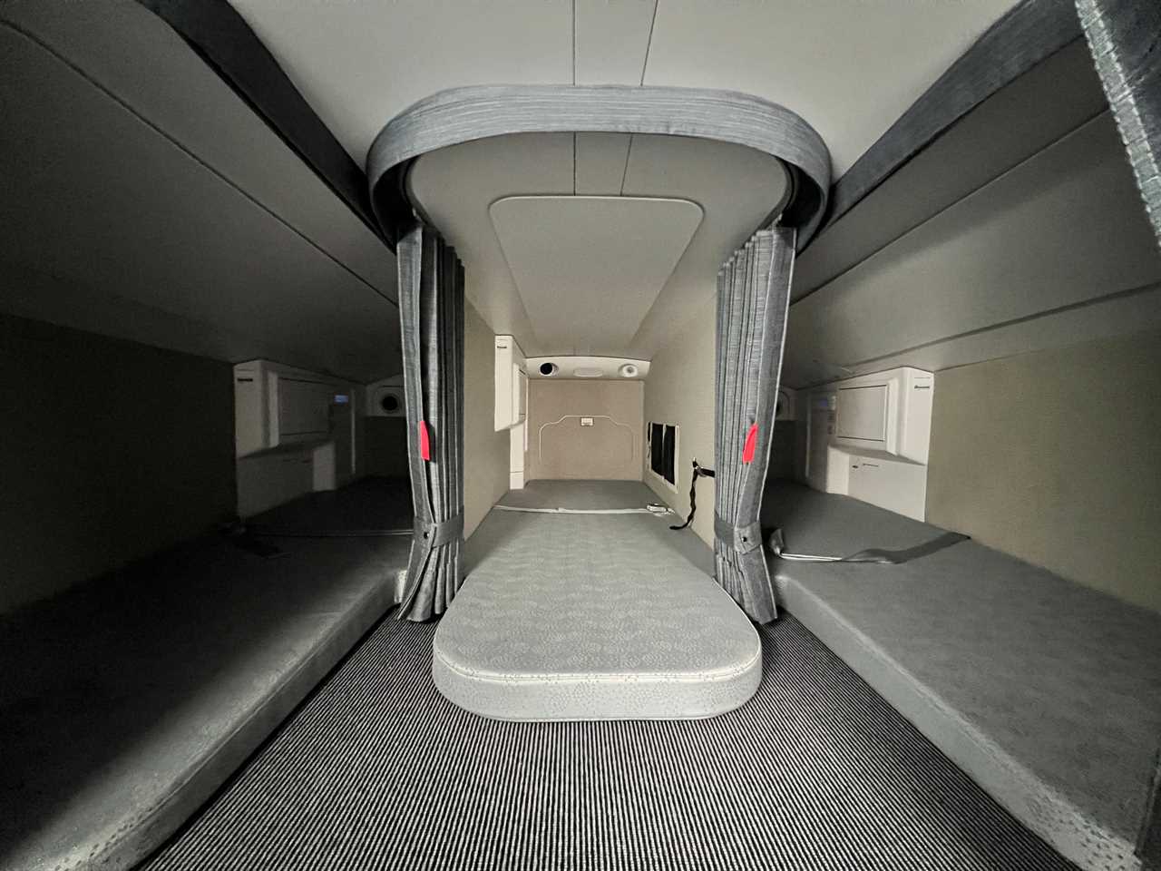 Three sleeping places in the A350's crew rest area including thin mattresses and curtains